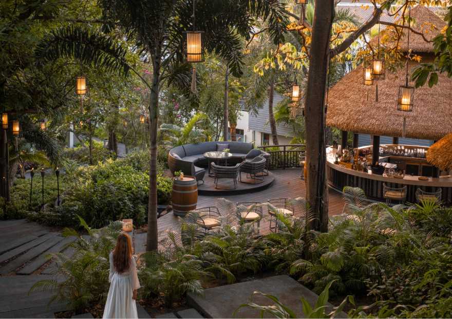 The Singing Bird Lounge cocktail bar beneath the rain tree at Anantara Lawana