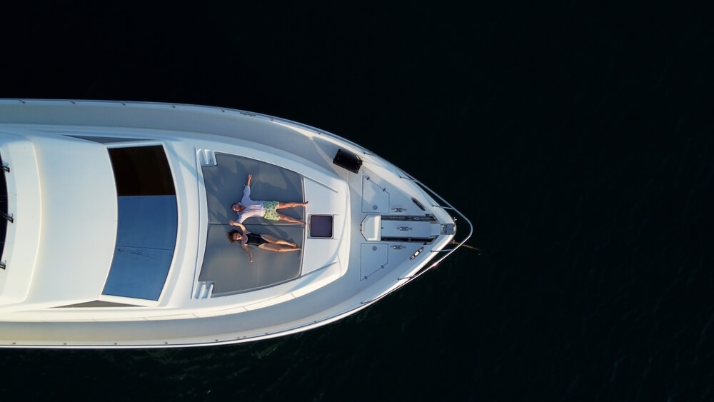 A private yacht at anchor in clear Thai water at dusk